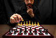 © Narayan - latin man with beard challenging in chess game, chess concept