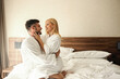 © Dusan Petkovic - A love flame full of passion, a weekend to relax. The beautiful blonde gently touching the man's face as he holds her in his arms. Intimacy in the bathrobes of crossed legs, smiling, loving, fire