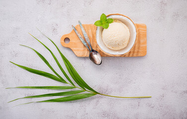 Fototapete - Coconut ice cream flavours in half of coconut setup on white stone background. Summer and Sweet menu concept.