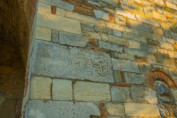 APOLLONIA, ALBANIA: Ancient stone wall and entrance to the Monastery Pojan of Saint Mary in Apollonia.