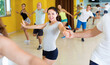 © JackF - Merry happy positive couples dancing in studio and smiling