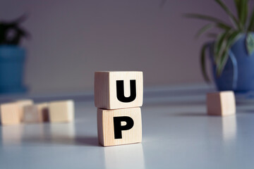 Canvas Print - Word UP made from wooden letters on pink background. Concept of growth