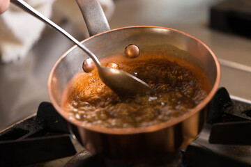 Chef making caramel in a pan on the fire