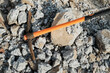 pickaxe hoe lying on crushed stones. hand-held percussion tool designed for working on stone, stony ground, very dense ground