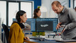 © DC Studio - Industrial designer holding tablet discussing with woman engineer while working in CAD program, designing new components, comparing 3D prototype with project from notepad, using pc with two monitors