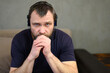 © Вячеслав Чичаев - Portrait of one man in headphones sitting at home. Posing for the camera.