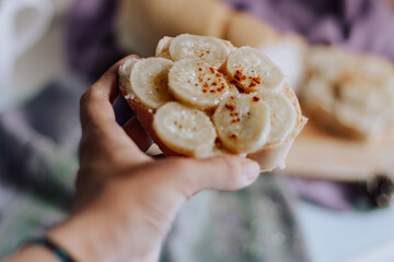 Sticker - Selective focus shot of a hand holding a banana toast