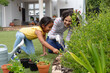 © Wavebreak Media - Smiling hispanic mother and daughter gardening, kneeling and planting in flower bed