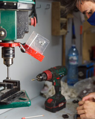 Poster - Vertical shot of a Spanish Caucasian man wearing a facemask, working in the warehouse