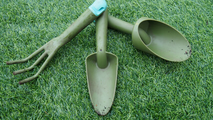 Sticker - Closeup shot of small plastic garden tools in the grass