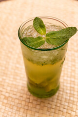 Wall Mural - High-angle shot of cocktail Mojito with lime and mint leaves on the table