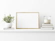 Horizontal wooden frame mockup with green olive twigs in vase and candle on white wall background. A4, A3, A size, 3d rendering, illustration