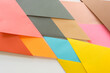 © eugen - triangle-shaped folded construction paper background - orange red yellow pink grey brown tan sand