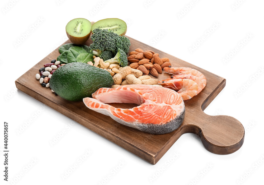 Board with healthy products rich in vitamin E on white background