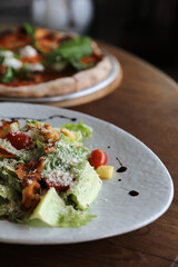 Wall Mural - caesar salad appetizer on wooden background