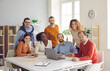 Happy diverse group of people different age nationality work in office together. Multiethnic freelancer team sitting and standing looking at camera portrait. Young adult professional business meeting