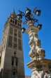 Vertical shot of the Giralda bell tower in Seville, Spain on a blue sky background