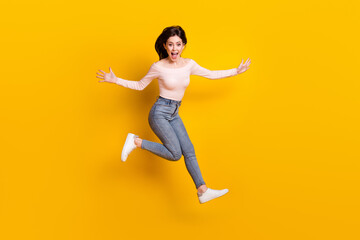 Sticker - Full size photo of young happy excited funky girl jumping running in iar screaming isolated on yellow color background