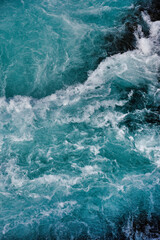 Wall Mural - bruarfoss waterfall in iceland as an abstract of the blue water and whitewater from above