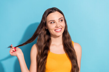 Wall Mural - Photo portrait girl smiling touching long hair looking copyspace isolated pastel blue color background