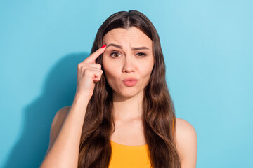 Wall Mural - Photo portrait girl touching forehead with finger showing mad crazy isolated pastel blue color background