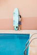 © LIGHTSY STUDIO/Westend61 - Pre-adolescent boy standing with surfboard at poolside