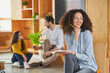 © Annika List/Westend61 - Female entrepreneur holding book with colleagues in background at office