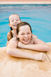 © LIGHTSY STUDIO/Westend61 - Cheerful siblings playing at poolside
