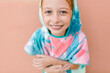 © LIGHTSY STUDIO/Westend61 - Smiling girl in bathrobe in front of beige wall