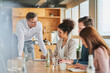 © Annika List/Westend61 - Entrepreneurs discussing while sitting with colleagues in meeting