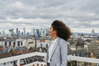© Annika List/Westend61 - Thoughtful businesswoman looking at view on rooftop in city