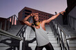 © Antonio Ovejero Diaz/Westend61 - Young man in dab pose while standing on metal staircase
