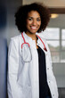 © Buero Monaco/Westend61 - Smiling female doctor standing by wall in hospital