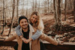 © Gala Mart√≠nez L√≥pez/Westend61 - Cheerful couple enjoying leisure time in forest during autumn