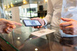 © Jose Carlos Ichiro/Westend61 - Mature man showing QR code on mobile phone at receptionist hotel desk