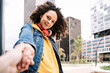 © COROIMAGE/Westend61 - Beautiful woman holding hand on friend in city