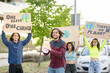 © Jose Carlos Ichiro/Westend61 - Smiling male activist protesting against climate change on city street