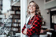 © Joseffson/Westend61 - Confident female entrepreneur with arms crossed standing at cafe door