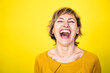 © Joseffson/Westend61 - Woman laughing in front of yellow background