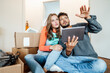 © Joseffson/Westend61 - Young couple sitting with digital tablet planning at home