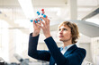 © Joseffson/Westend61 - Mature expertise holding molecular structure model at workshop