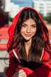 © Julio Rodriguez/Westend61 - Smiling blue eyed teenage girl wearing red hood jacket on sunny day