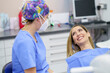 © Javier Sanchez Mingorance/Westend61 - Smiling female patient talking with dentist at clinic
