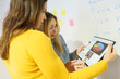 © Javier Sanchez Mingorance/Westend61 - Female professionals discussing over digital tablet at office