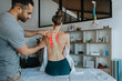 © Infinite Lux/Westend61 - Physiotherapist treating female patient's bent spine