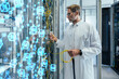 © Infinite Lux/Westend61 - Mature male technician plugging fiber optic cable at data center