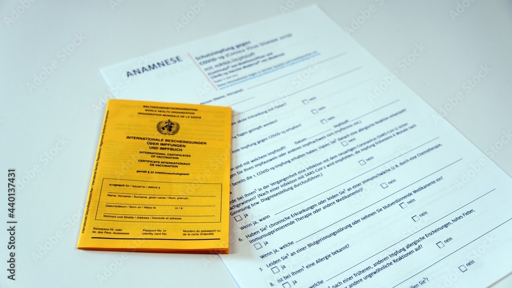 Yellow vaccination certificate with anamnesis sheet - obrazy, fototapety, plakaty 