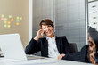 © Eugenio Marongiu/Westend61 - Happy businesswoman looking away while talking on smart phone at desk