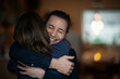 © Malte Jager/Westend61 - Smiling man embracing girlfriend at home