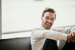 © Malte Jager/Westend61 - Smiling man sitting in front of bright window at home